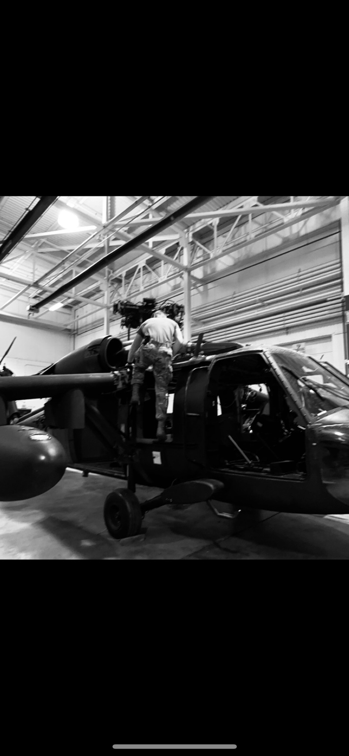 Zachary Oswald performing maintenance on a Black Hawk helicopter